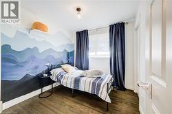 Bedroom featuring dark wood-style flooring - 