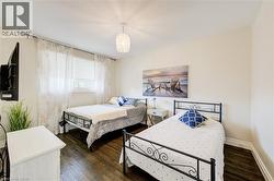 Bedroom featuring dark wood-type flooring - 