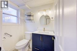 Bathroom with vanity and light tile patterned floors - 