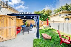 Fenced backyard featuring a gazebo and a patio area - 