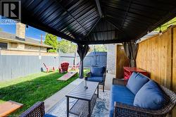 Fenced backyard featuring an outdoor living space and a patio area - 