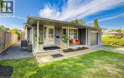 Ranch-style house with a porch, brick siding, and an attached garage - 