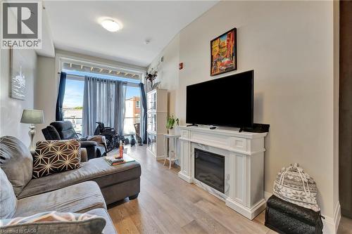 Living room with light wood-type flooring and a premium fireplace - 85B Morrell Street Unit# 117, Brantford, ON - Indoor Photo Showing Living Room With Fireplace