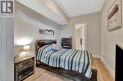 Bedroom featuring light wood-type flooring and connected bathroom - 