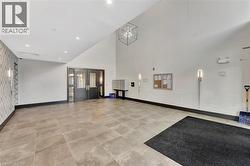 Community lobby featuring high vaulted ceiling and recessed lighting - 