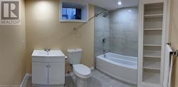 Full bathroom with toilet,  shower combination, vanity, and baseboards - 