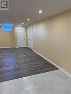 Spare room featuring recessed lighting, wood finished floors, and baseboards - 