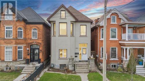 Townhome / multi-family property featuring stucco siding and roof with shingles - 181 West Avenue N, Hamilton, ON - Outdoor With Facade