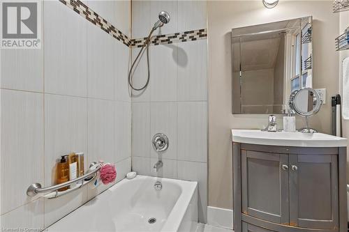 Bathroom with vanity and washtub / shower combination - 181 West Avenue N, Hamilton, ON - Indoor Photo Showing Bathroom