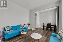 Living area with baseboards, wood finished floors, and recessed lighting - 