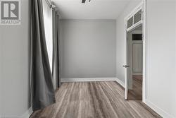 Empty room featuring baseboards and wood finished floors - 