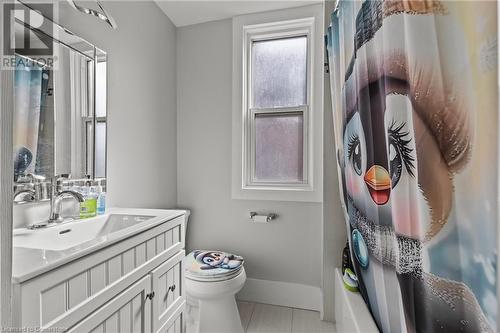 Bathroom with vanity, baseboards, toilet, and curtained shower - 181 West Avenue N, Hamilton, ON - Indoor Photo Showing Bathroom