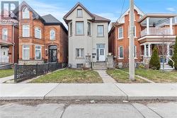 Townhome / multi-family property featuring stucco siding and a front lawn - 