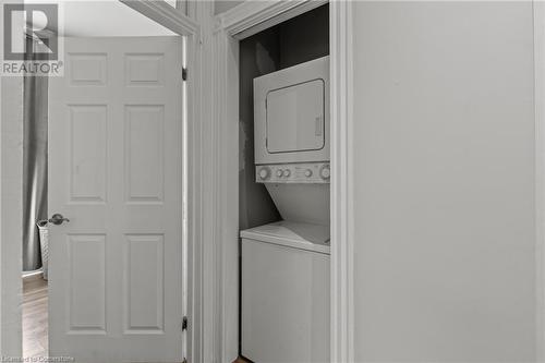 Clothes washing area with stacked washer and clothes dryer and laundry area - 181 West Avenue N, Hamilton, ON - Indoor Photo Showing Laundry Room