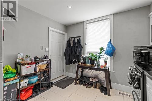 Entrance foyer with light tile patterned flooring, baseboards, and visible vents - 181 West Avenue N, Hamilton, ON - Indoor