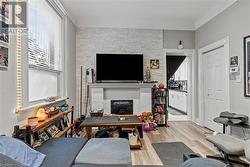 Living area featuring a large fireplace and wood finished floors - 