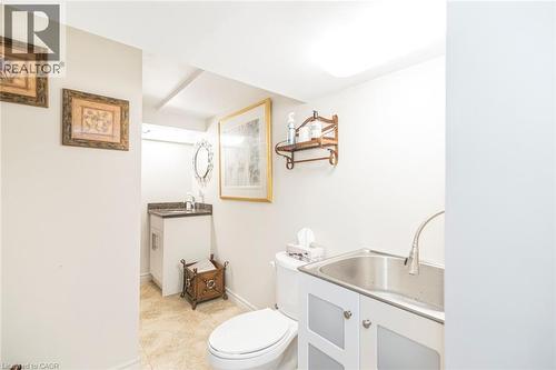 Lower level four piece bathroom with washer dryer and wash  basin - 199 Kimberly Drive, Hamilton, ON - Indoor Photo Showing Bathroom