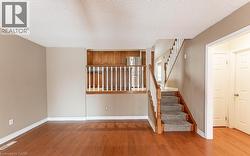 Stairway featuring wood finished floors and a textured ceiling - 