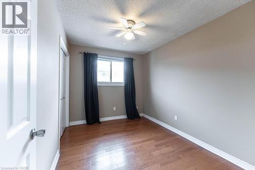 Empty room featuring wood finished floors, a textured ceiling, and a ceiling fan - 162 Solomon Crescent, Hamilton, ON - Indoor Photo Showing Other Room