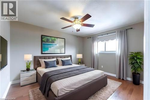 Bedroom with wood finished floors and a ceiling fan - 162 Solomon Crescent, Hamilton, ON - Indoor Photo Showing Bedroom
