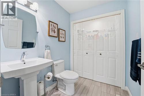Laundry room on main level in powder room (behind sliding doors) - 53 Heron'S Landing Unit# 31, Woodstock, ON - Indoor Photo Showing Bathroom