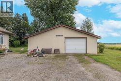 Detached garage featuring dirt driveway - 