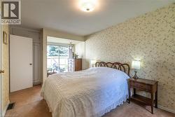Carpeted bedroom featuring wallpapered walls - 