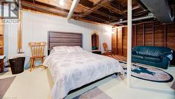 Bedroom with wood walls and concrete floors - 
