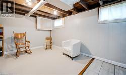 Sitting room with wood walls and baseboards - 