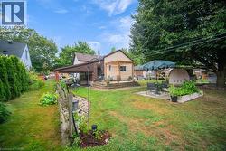 Back of house featuring a patio area, a yard, and a storage shed - 