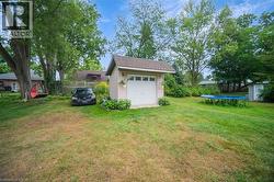 View of yard featuring a trampoline and a storage unit - 