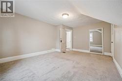 Empty room with light carpet and a textured ceiling - 