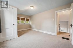 Unfurnished bedroom featuring light colored carpet and a textured ceiling - 
