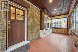 Unfurnished sunroom with brick wall, wood-type flooring, wood ceiling, and recessed lighting - 