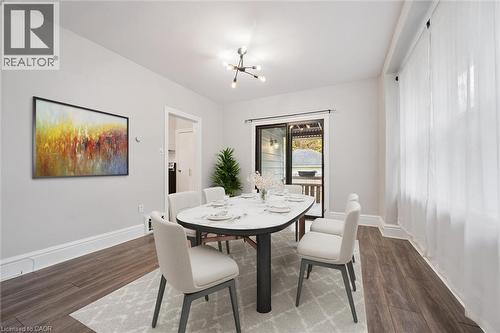 Dining space with a chandelier and dark wood finished floors - 41 Rose Street, Kitchener, ON - Indoor Photo Showing Dining Room