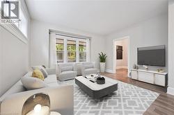 Living room featuring wood finished floors and baseboards - 