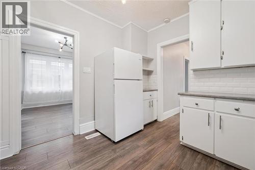 Kitchen featuring open shelves, freestanding refrigerator, decorative backsplash, white cabinets, and crown molding - 41 Rose Street, Kitchener, ON - Indoor Photo Showing Kitchen