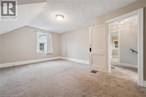 Additional living space with healthy amount of natural light, a textured ceiling, carpet floors, and lofted ceiling - 41 Rose Street, Kitchener, ON - Indoor Photo Showing Other Room