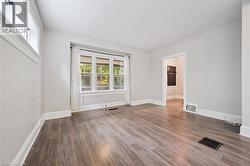 Spare room featuring wood finished floors and baseboards - 