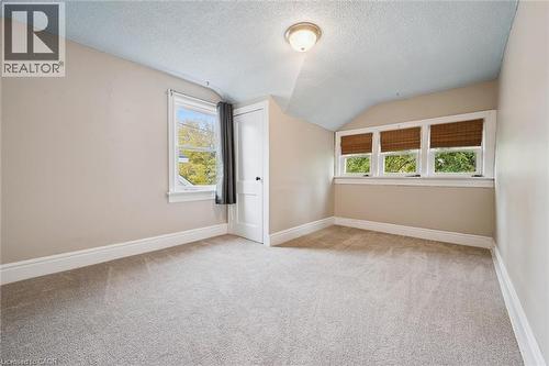 Additional living space featuring a textured ceiling, lofted ceiling, and light carpet - 41 Rose Street, Kitchener, ON - Indoor Photo Showing Other Room