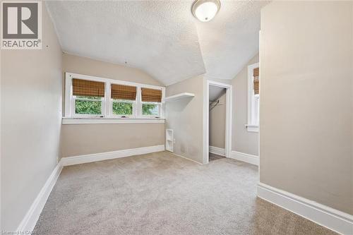 Unfurnished room with a textured ceiling, vaulted ceiling, and light colored carpet - 41 Rose Street, Kitchener, ON - Indoor Photo Showing Other Room