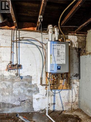 Unfinished Basement Showing Modern On Demand Hot Water Tank - 1 Rathgar Street, London, ON - Indoor Photo Showing Basement