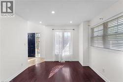 Unfurnished room featuring hardwood / wood-style flooring and recessed lighting - 