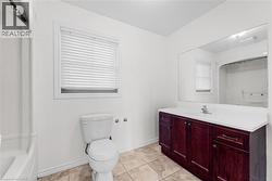 Full bath featuring vanity, light tile patterned flooring, and bathing tub / shower combination - 