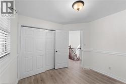 Unfurnished bedroom with light wood-style flooring and a closet - 