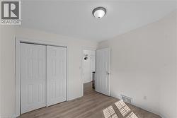 Unfurnished bedroom featuring light wood-type flooring and a closet - 