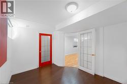 Spare room with dark wood-style floors and baseboards - 