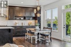 Extra Counter Space and Upper Cabinetry with a Built-in Wine Rack - 