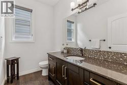 Main Floor Bathroom with Tile backsplash and an undermount sink - 