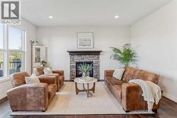 Spacious living area centered around a beautiful gas fireplace with full stone surround and mantle - 